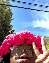 a woman wearing a pink crocheted hat