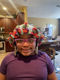 a little girl wearing a crocheted hat